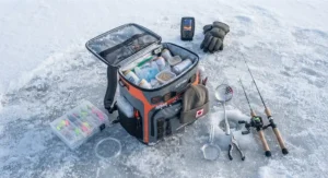 Layout of a backpack cooler for ice fishing alongside essential winter angling gear like rods and scoops.