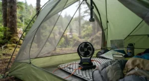 A USB rechargeable camping fan resting inside a mesh tent interior during a backcountry camping trip in British Columbia.